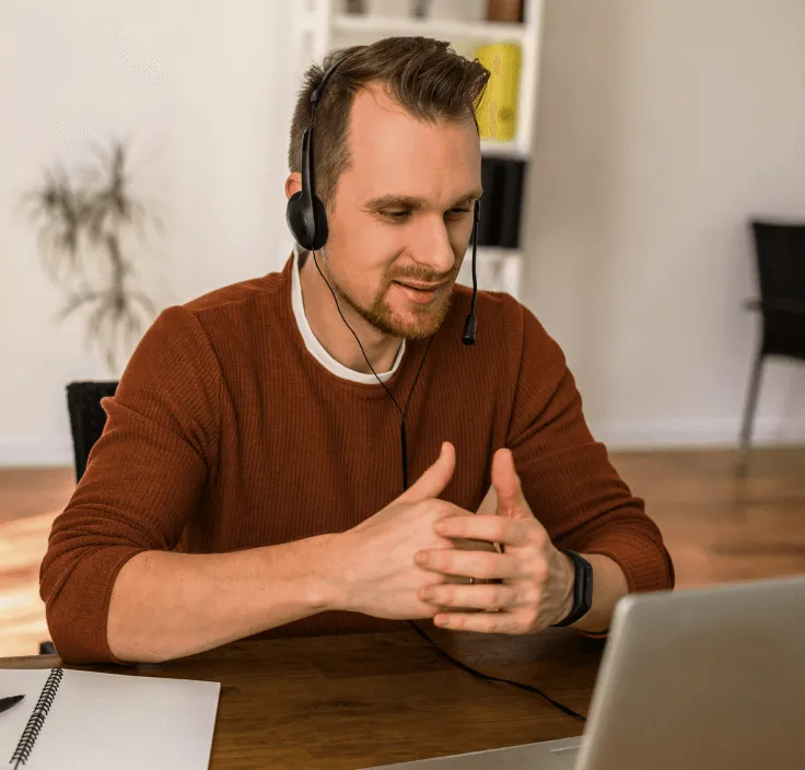 A man attending a video meeting in his home office