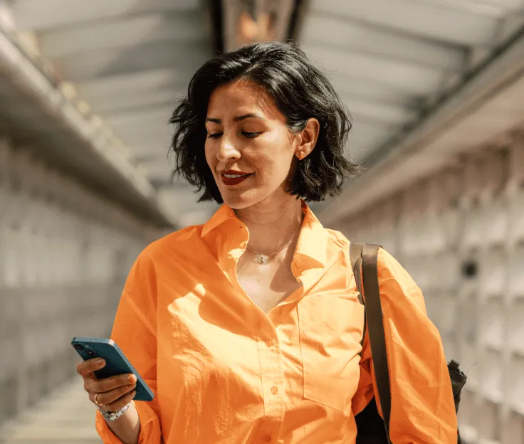 A woman sending an SMS from her mobile phone