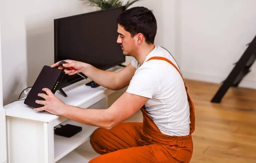 A man installing video conferencing equipment