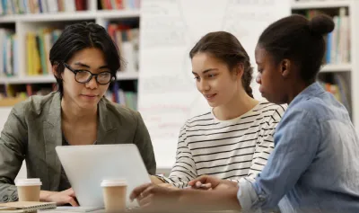 A group of three individuals planning and organizing a virtual event to be hosted on RingCentral Events