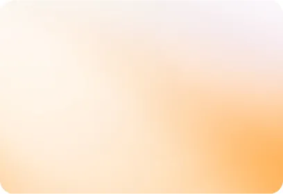 A woman in a yellow sweater sits at a desk with a laptop and headphones