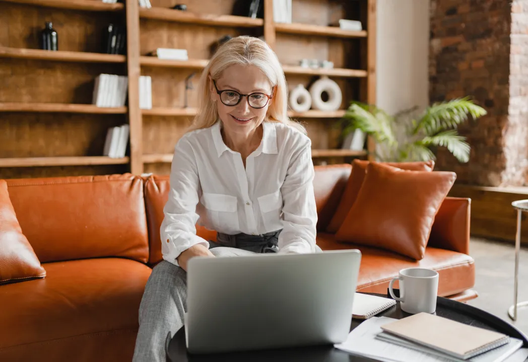 Female employee smiling while taking a RingCentral video call on laptop