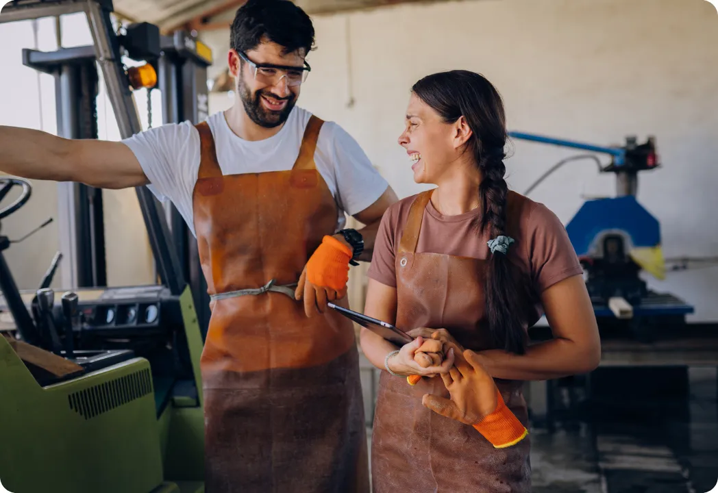 Two workers are smiling and talking to each other
