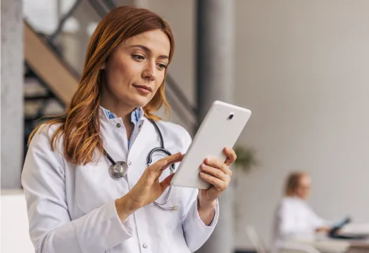 A female doctor using RingCentral app on tablet